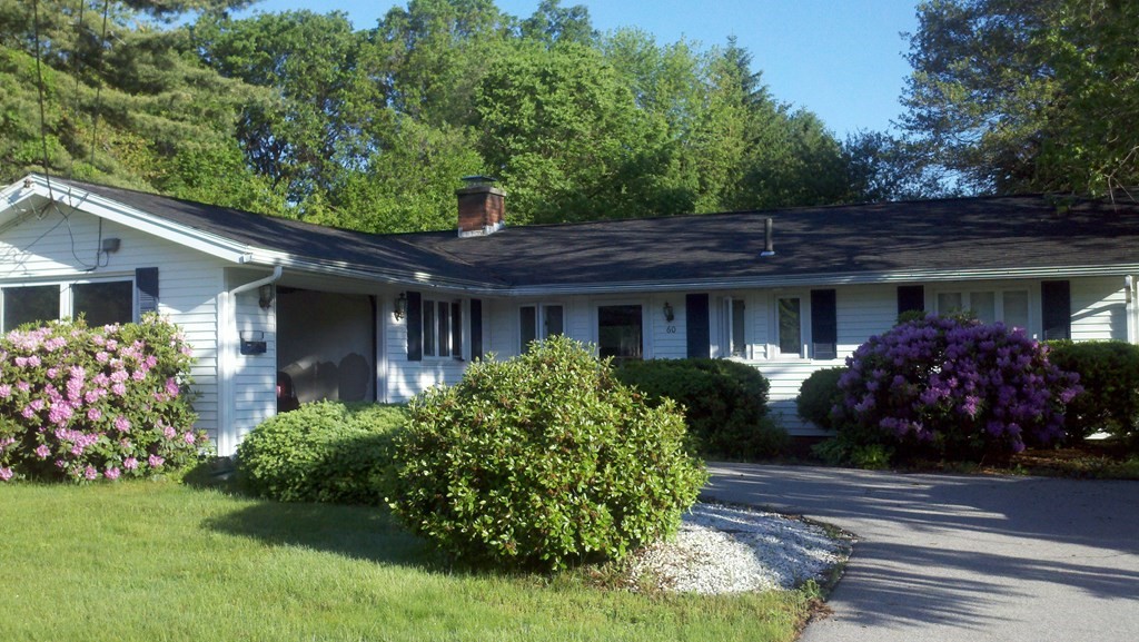60 Gregory Road Framingham, MA 01701 - Photo 2 of 14 a front view of a house with a garden