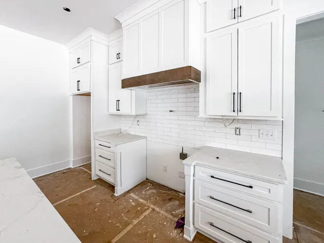 a kitchen with a stove cabinets and a sink