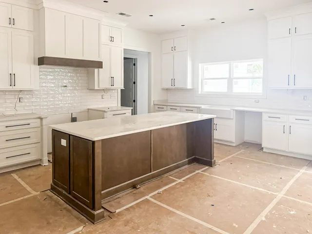 a kitchen with a sink cabinets and window
