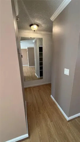 an entryway in a hall with wooden floor
