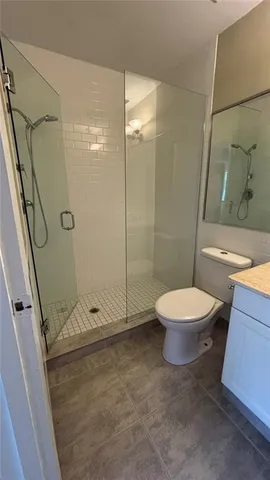 a bathroom with a toilet and a shower