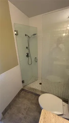 a bathroom with a toilet and shower
