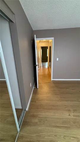 a view of a hallway with wooden floor