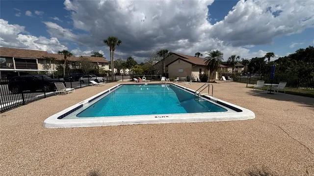 a view of outdoor space with swimming pool and seating
