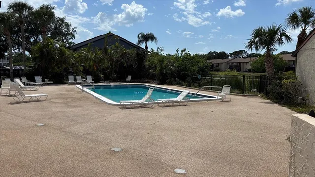 a view of a house with pool and a yard