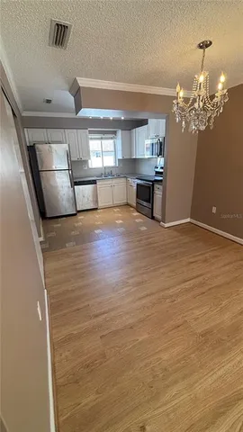 a view of a livingroom with a kitchen