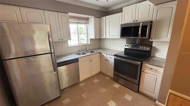 a white refrigerator freezer sitting inside of a kitchen