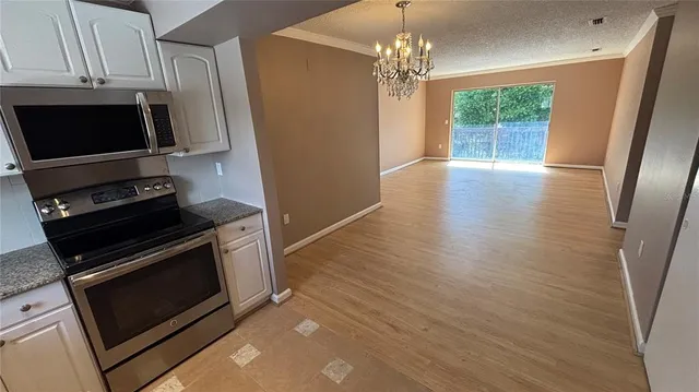 a kitchen with stainless steel appliances a stove microwave and sink