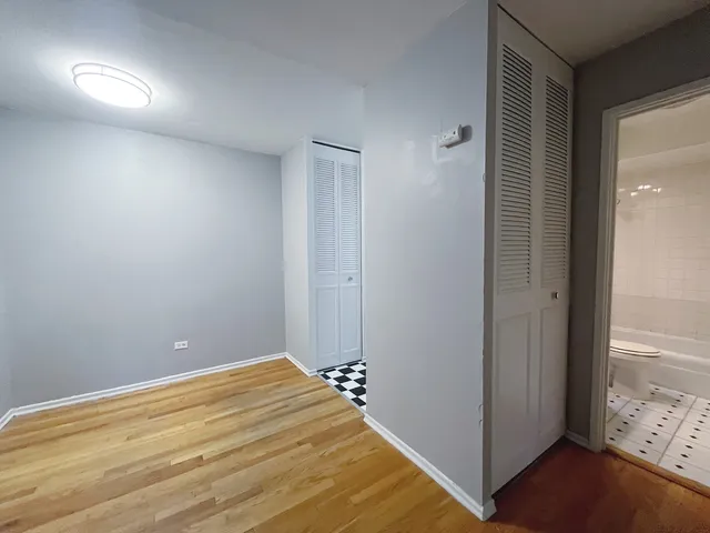 a view of a room with wooden floor and closet