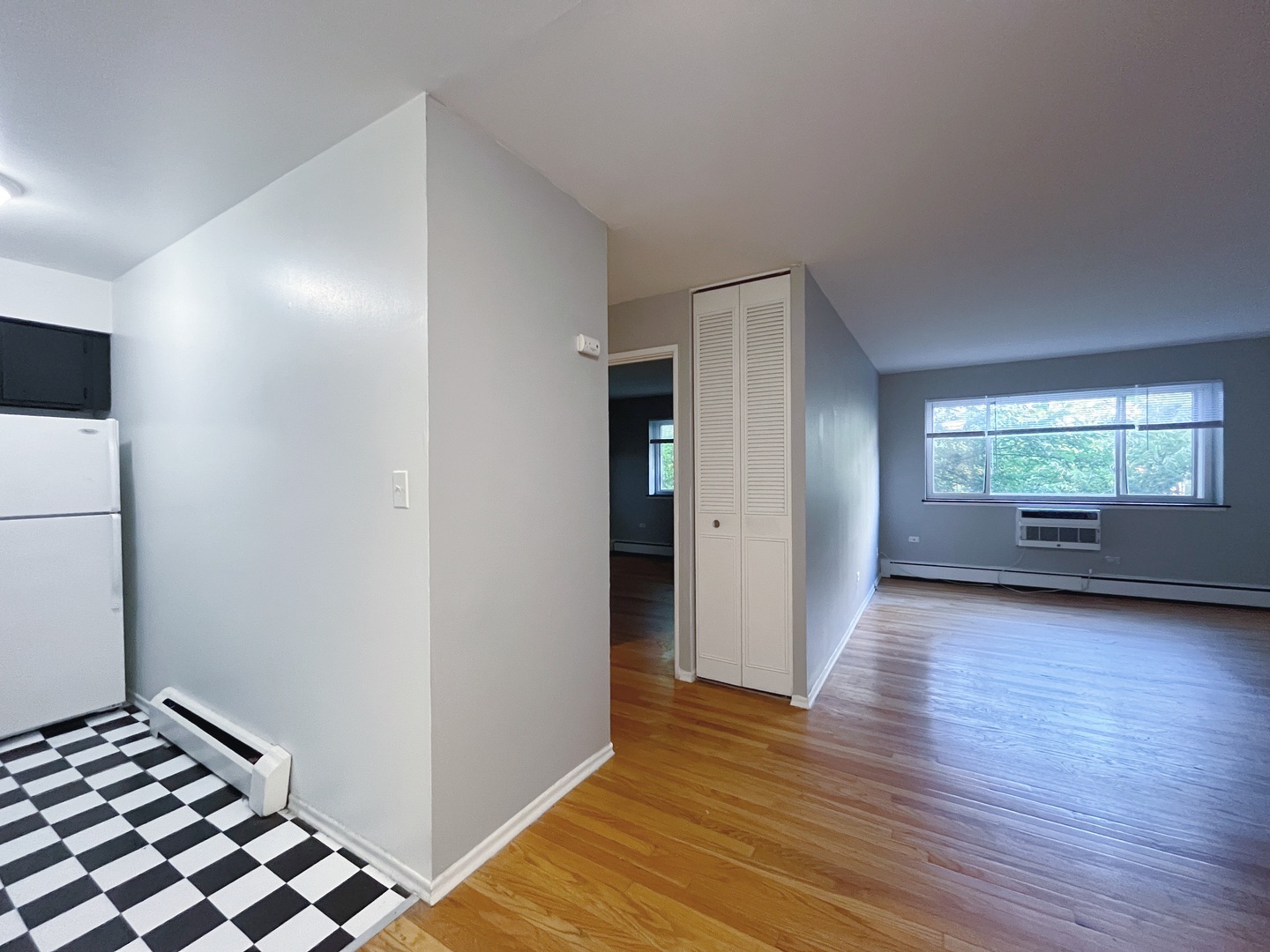 736 West Buena Avenue, Unit 307 Chicago, IL 60613 - Photo 5 of 9 a view of an empty room with window and wooden floor