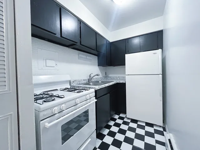 a kitchen with a refrigerator and a stove