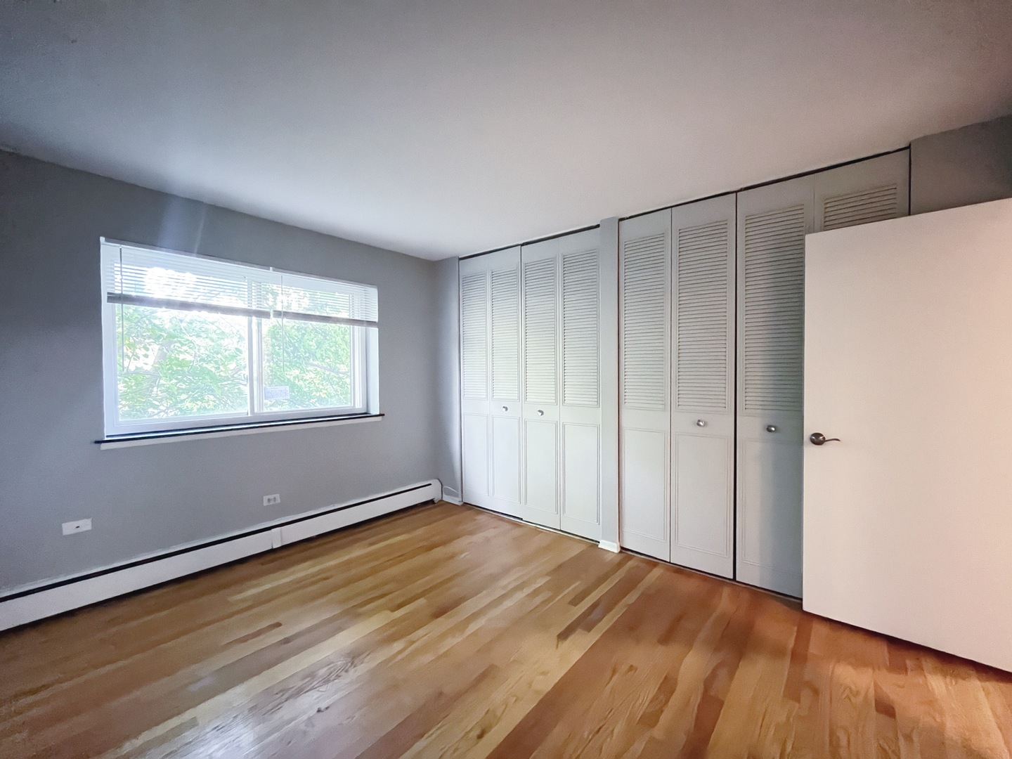 736 West Buena Avenue, Unit 307 Chicago, IL 60613 - Photo 7 of 9 a view of an empty room with wooden floor and a window