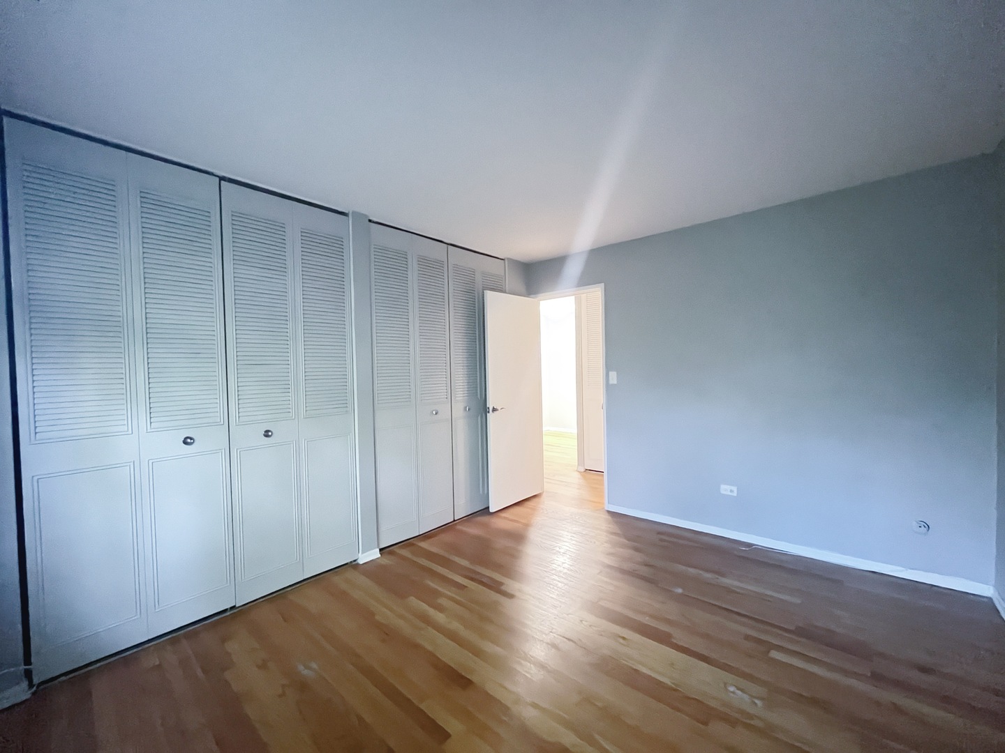 736 West Buena Avenue, Unit 307 Chicago, IL 60613 - Photo 8 of 9 a view of an empty room with wooden floor