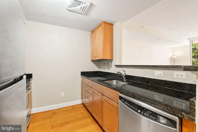 a view of a kitchen counter space and a sink