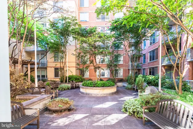 a front view of a house with a yard and outdoor seating
