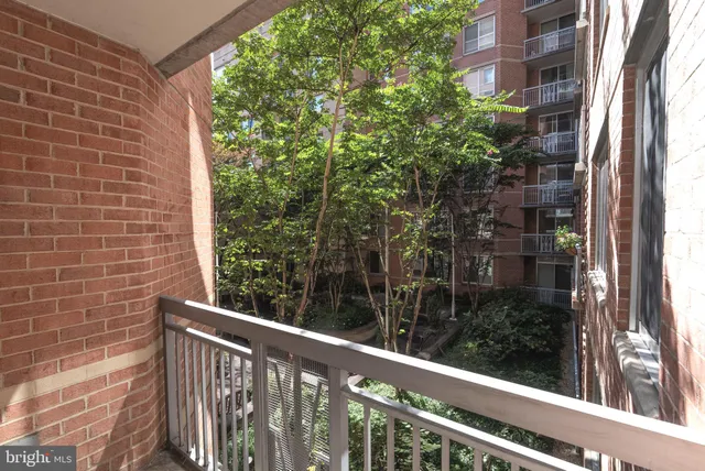 a view of a balcony with a tree