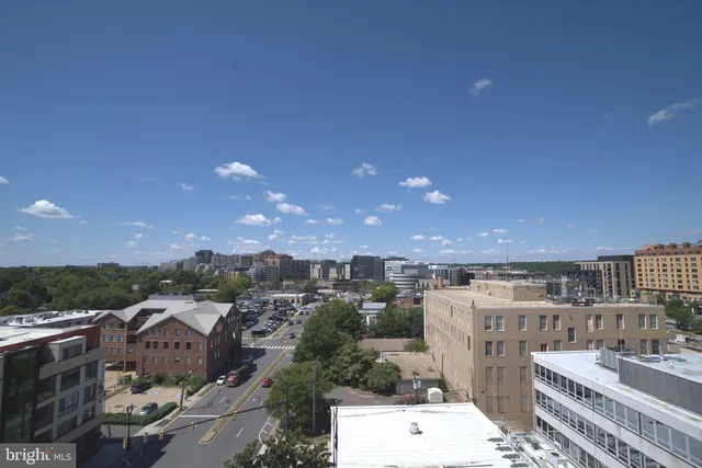 a view of a swimming pool with lake and seating in back