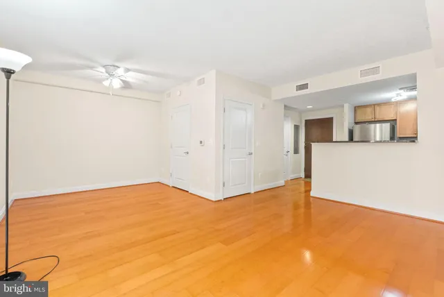 an empty room with fan and entrance