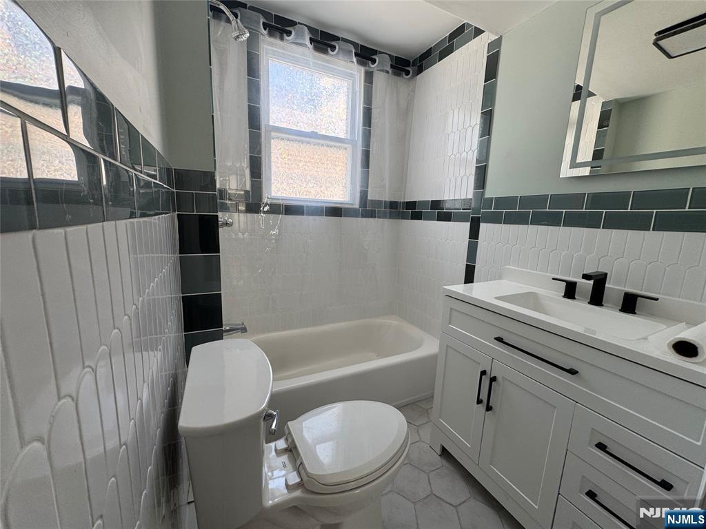 138 Carlton Avenue East Rutherford, NJ 07073 - Photo 11 of 14 a bathroom with a sink a toilet and bathtub