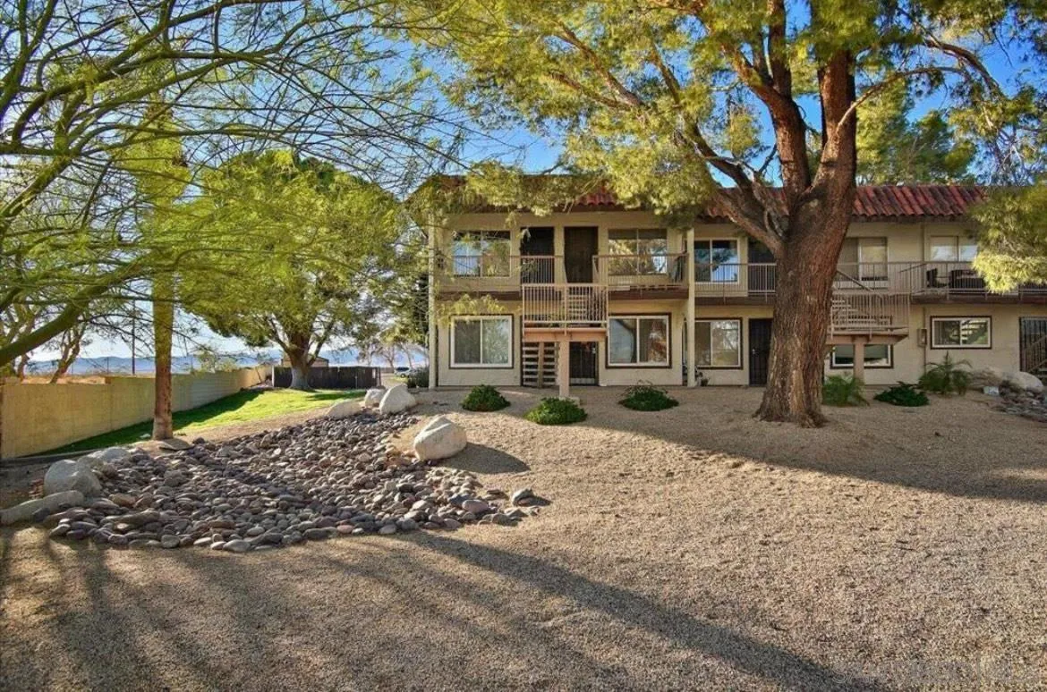 64281 Spyglass Avenue, Unit 42 Desert Hot Springs, CA 92240 - Photo 17 of 19 a front view of a house with a yard