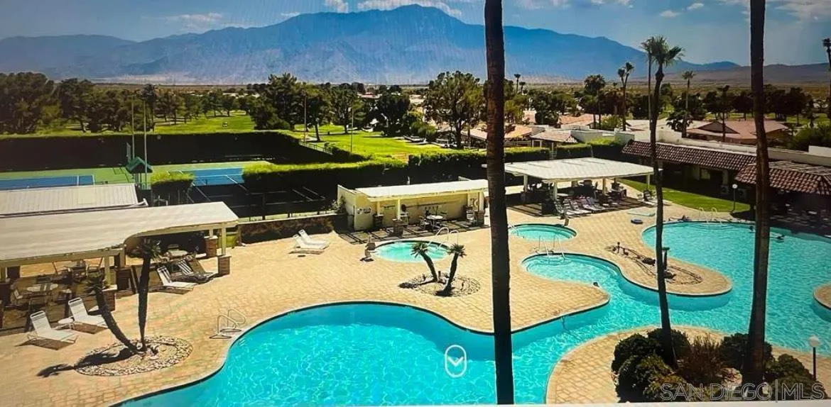64281 Spyglass Avenue, Unit 42 Desert Hot Springs, CA 92240 - Photo 18 of 19 a view of a swimming pool with a patio and a yard