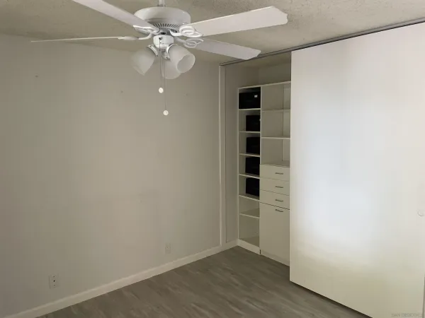 an empty room with a empty space and a ceiling fan