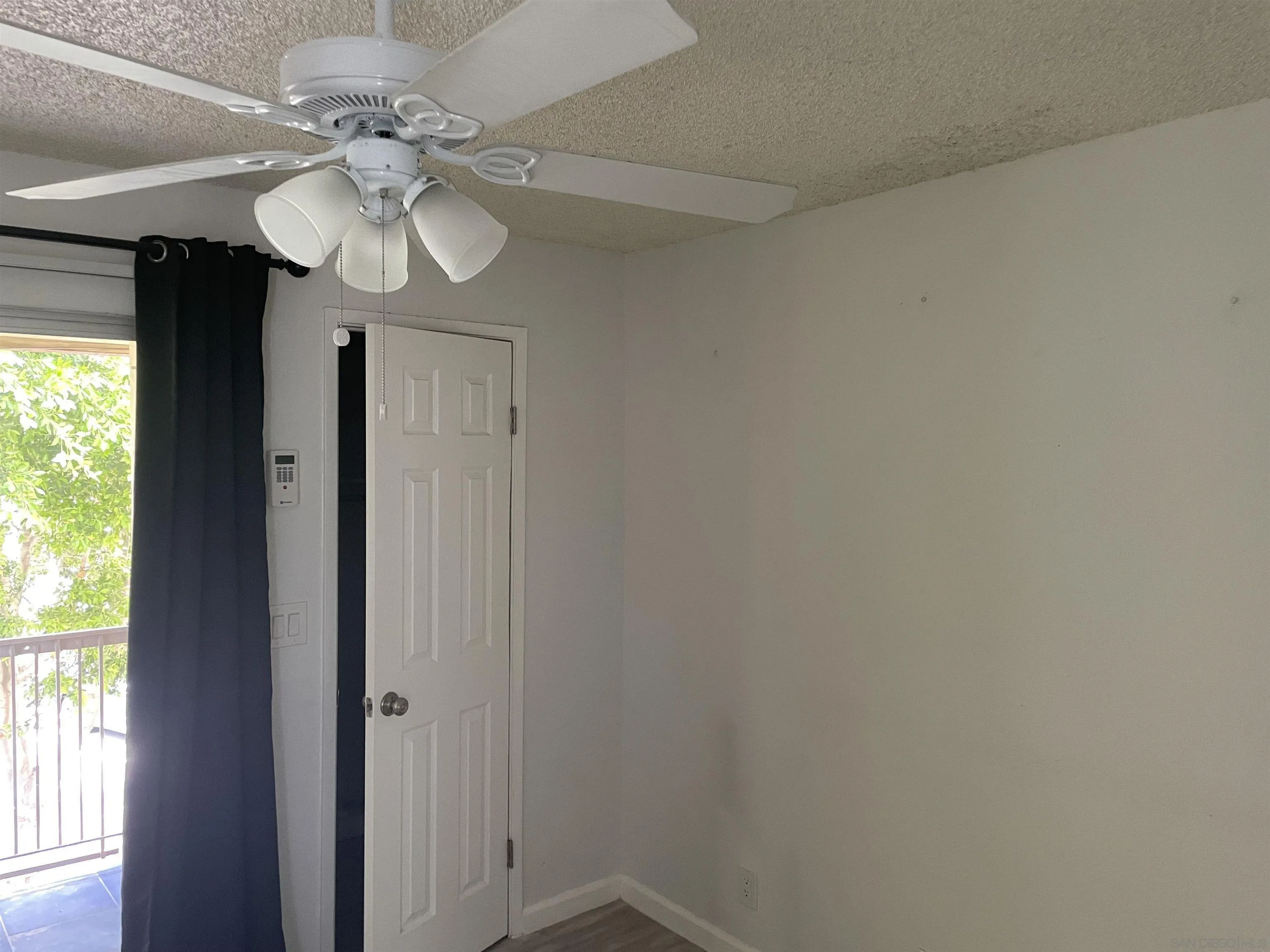 64281 Spyglass Avenue, Unit 42 Desert Hot Springs, CA 92240 - Photo 8 of 19 a view of a hallway with a chandelier fan and wooden floor