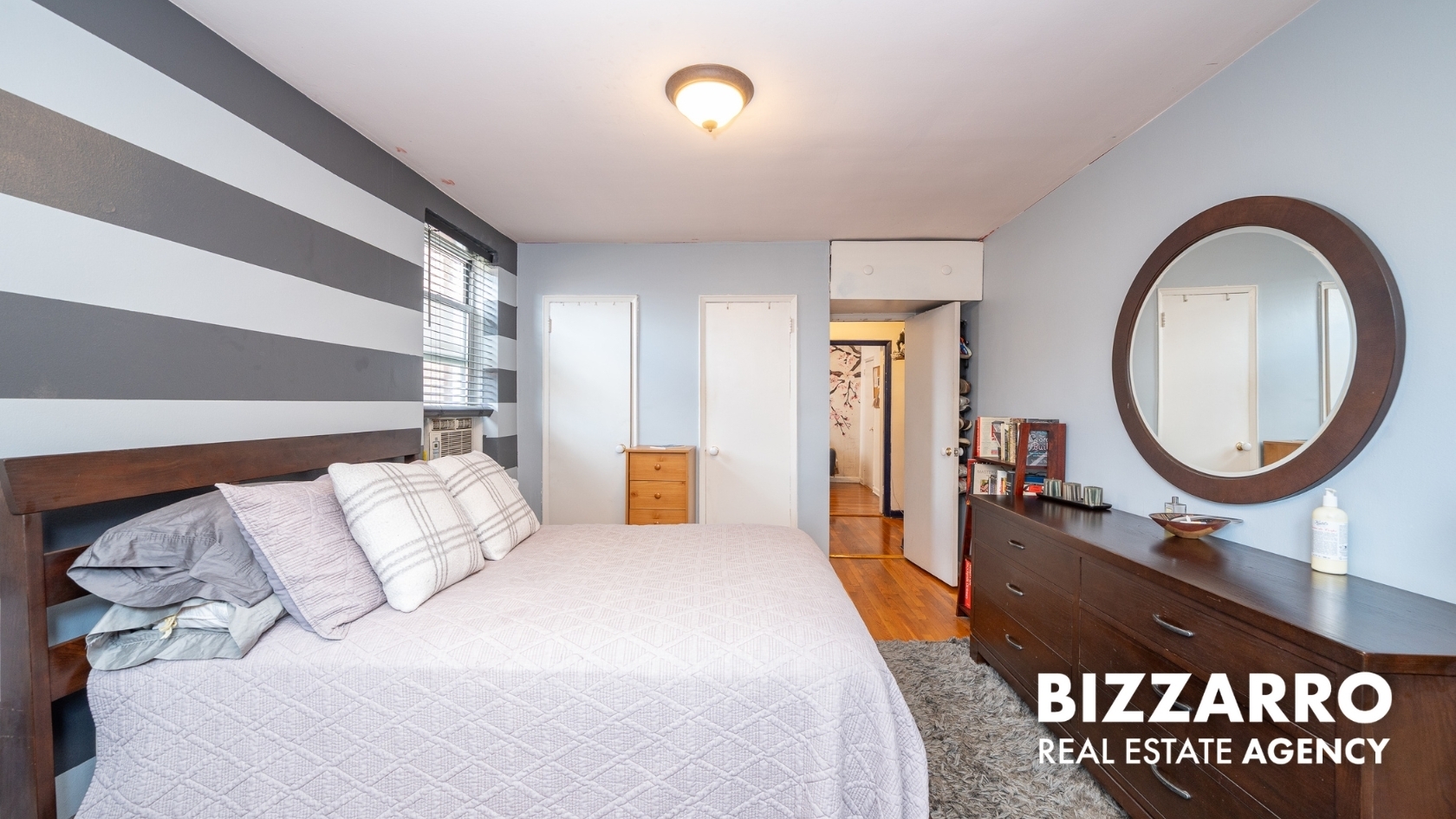 Undisclosed Address Manhattan, NY 10040 - Photo 11 of 14 a bed room with a bed mirror and a table