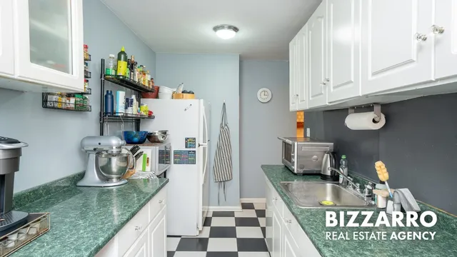 a kitchen with a stove and a white cabinets