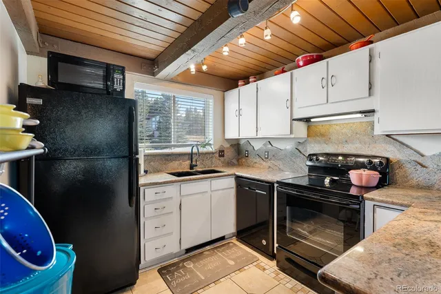 a kitchen with a sink appliances and cabinets