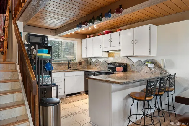 a kitchen with stainless steel appliances granite countertop a stove cabinets and a refrigerator