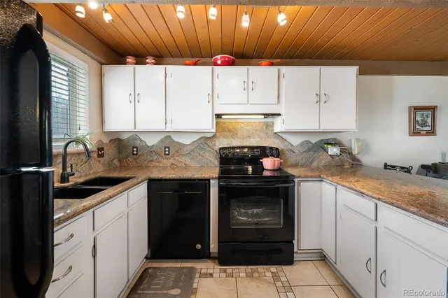 a kitchen with a sink stove and cabinets