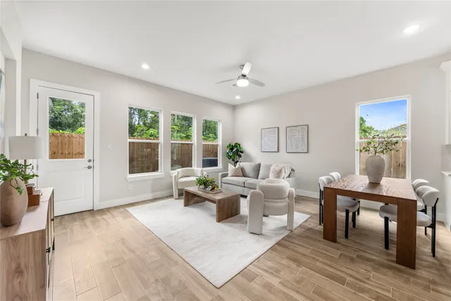 a living room with furniture and wooden floor