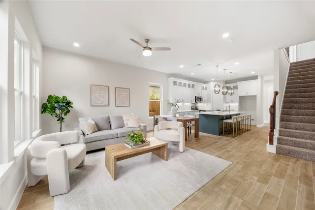 a living room with furniture and view of kitchen