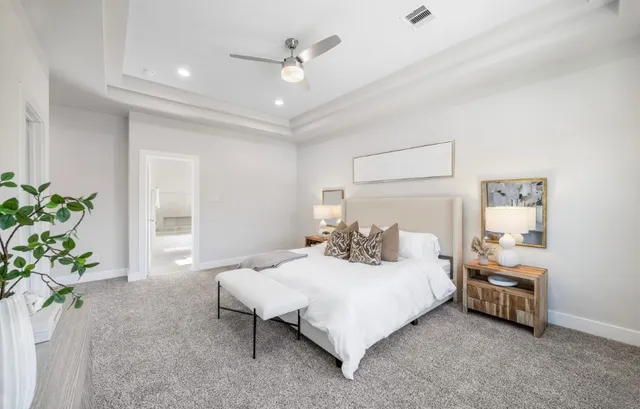 a bedroom with a bed and a potted plant