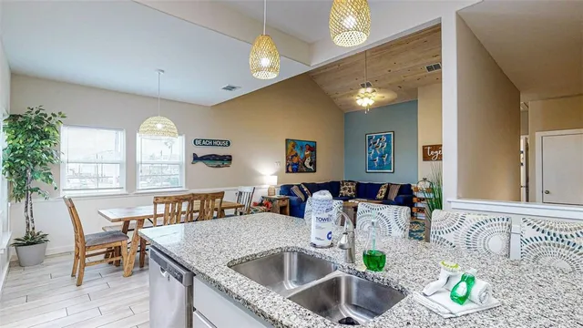 a kitchen with a table chairs and chandelier
