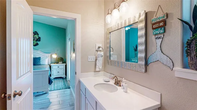 a en suite bathroom with a sink and mirror