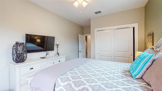 a bedroom with a bed and a flat screen tv