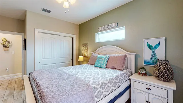 a bedroom with a bed and a chandelier