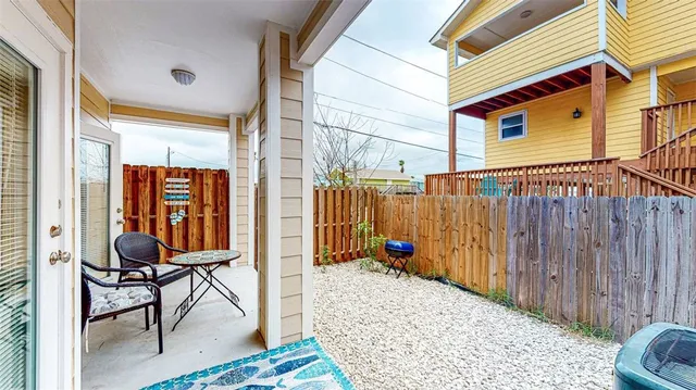 a backyard of a house with table and chairs