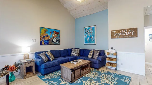 a living room with furniture a couch and paintings on the wall