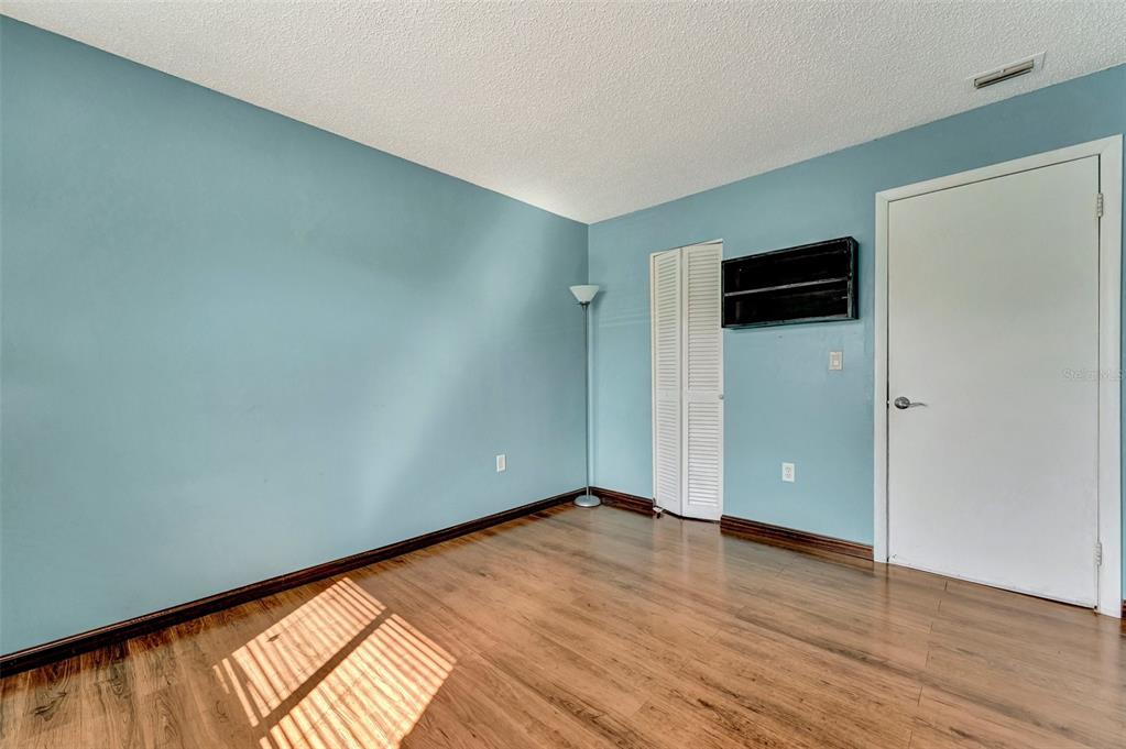 13300 Walsingham Road, Unit 56 Largo, FL 33774 - Photo 33 of 35 an empty room with wooden floor and closet