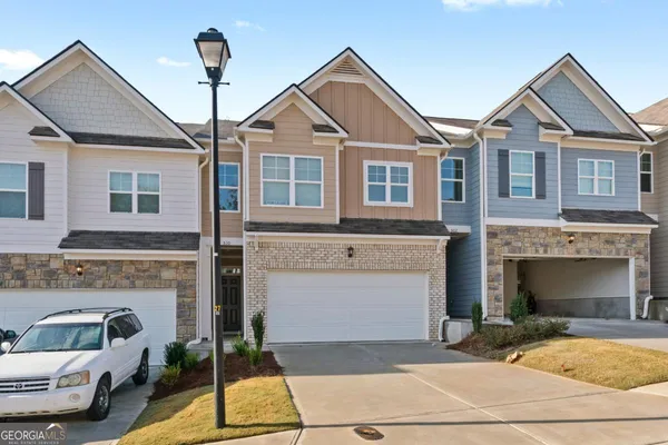a front view of a house with a yard and garage