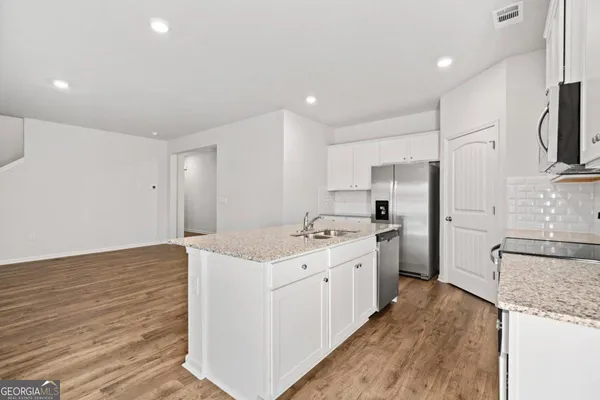 a kitchen with a sink stove and refrigerator