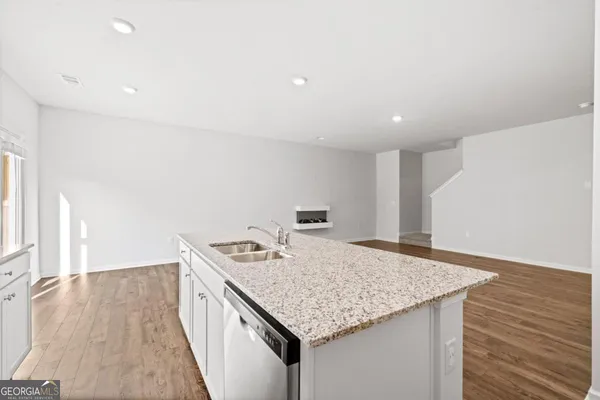 a kitchen that has a microwave a sink and a stove in it