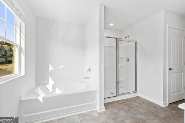 a bathroom with a bathtub and a shower