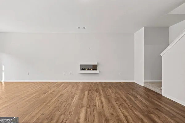 a view of a room with wooden floor