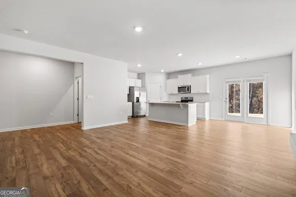 a view of kitchen with wooden floor and windows