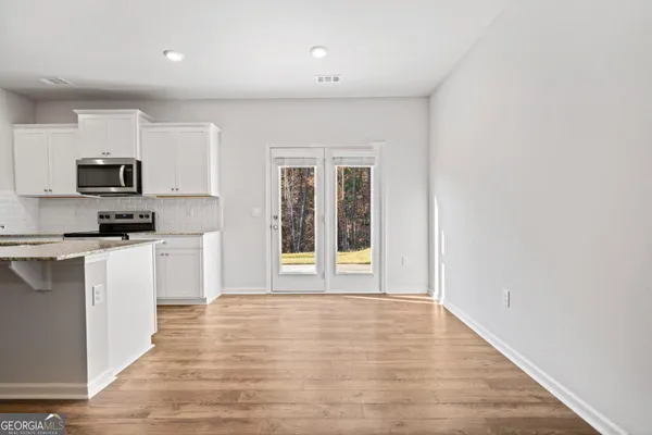 a view of a kitchen with microwave and cabinets