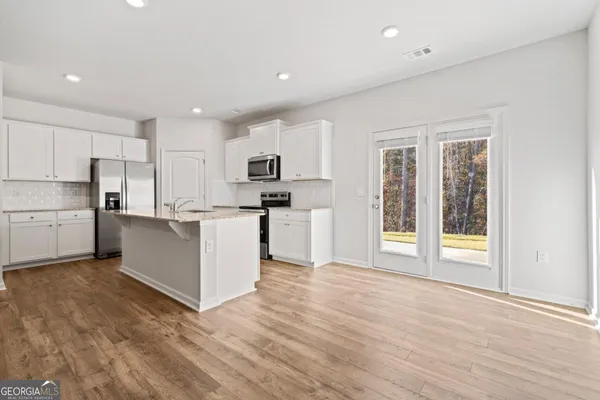 a view of a kitchen with electric appliances